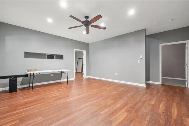 a bathroom with a granite countertop toilet sink and mirror