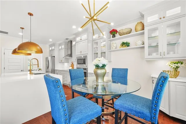 a living room with couches and dining table with wooden floor