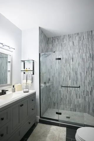 a bathroom with a double vanity sink mirror and toilet