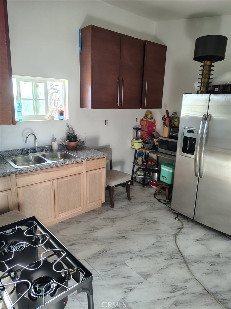 R6 137th Palmdale, CA 93591 - Photo 4 of 9 a kitchen with a sink stove and cabinets