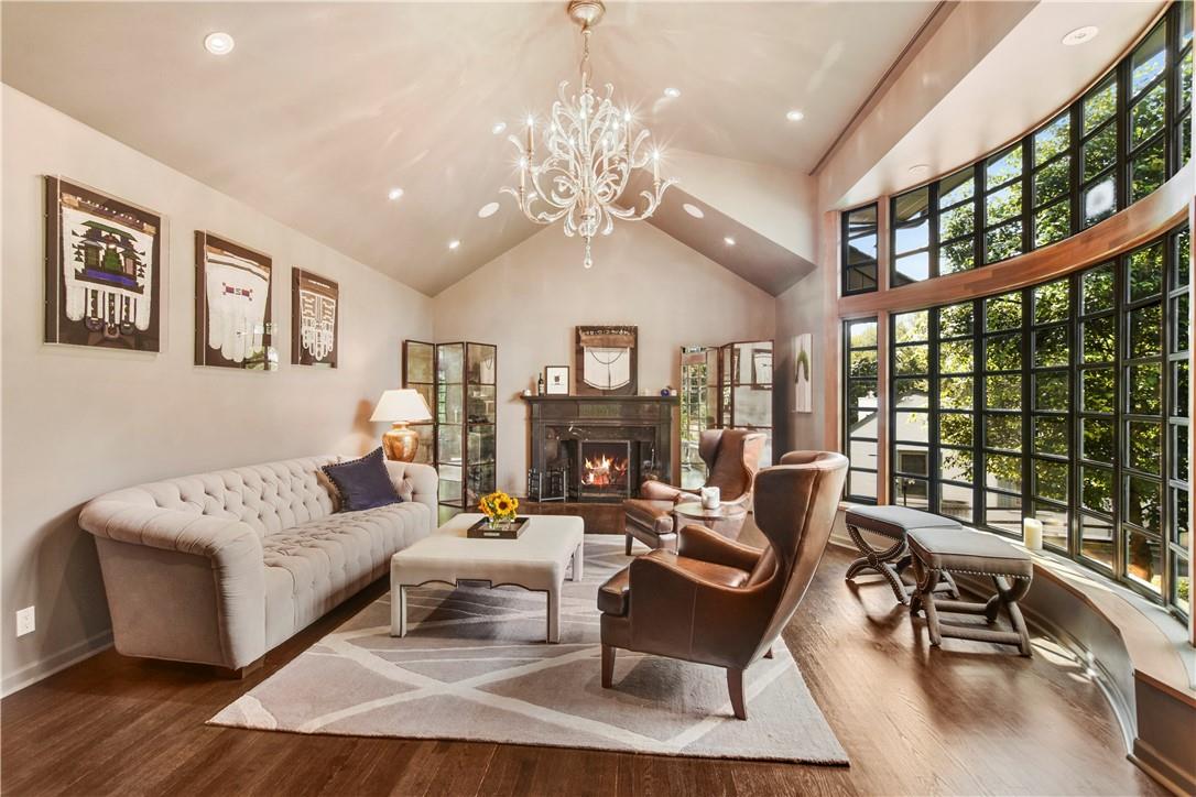 a living room with furniture a fireplace and a large window