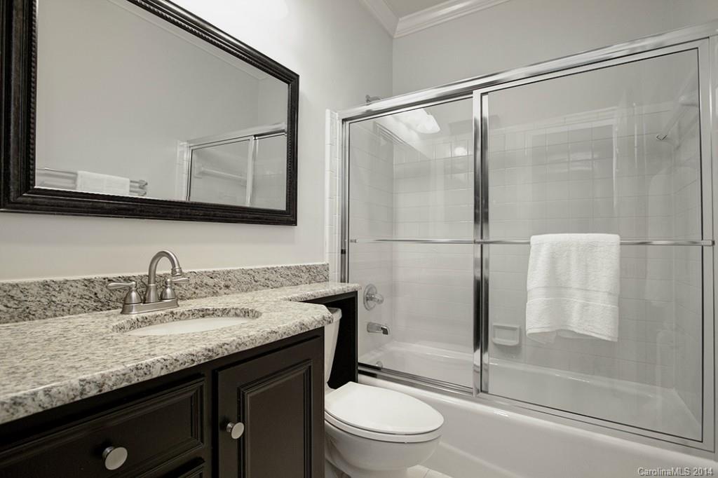 325 Queens Road, Unit 1 Charlotte, NC 28204 - Photo 14 of 17 a bathroom with a granite countertop sink toilet and shower