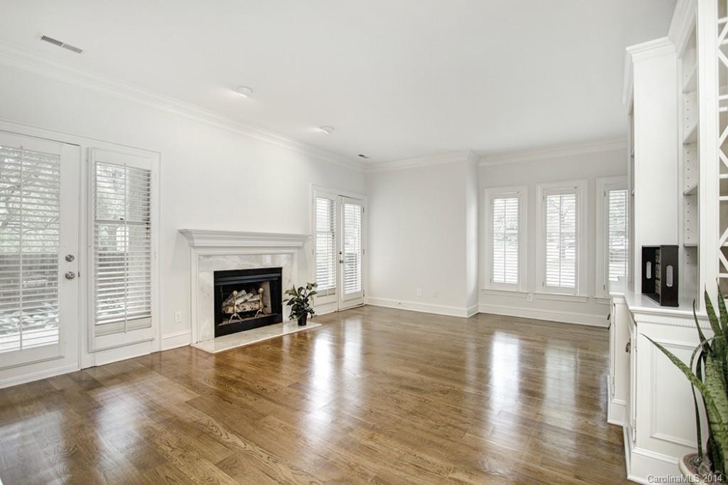 325 Queens Road, Unit 1 Charlotte, NC 28204 - Photo 8 of 17 a view of a livingroom with a fireplace a fireplace and wooden floor