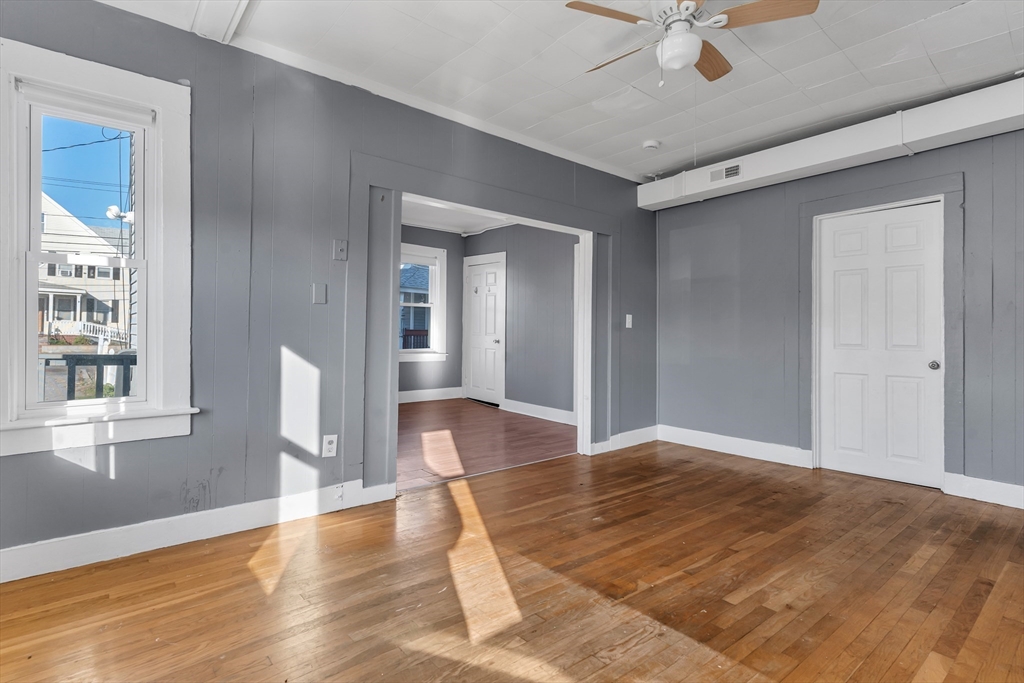 13 R Plain Street, Unit 2 Taunton, MA 02780 - Photo 7 of 21 a view of an empty room with wooden floor and a window