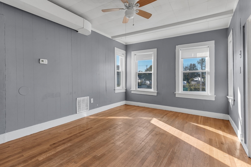 13 R Plain Street, Unit 2 Taunton, MA 02780 - Photo 8 of 21 a view of an empty room with a window and wooden floor