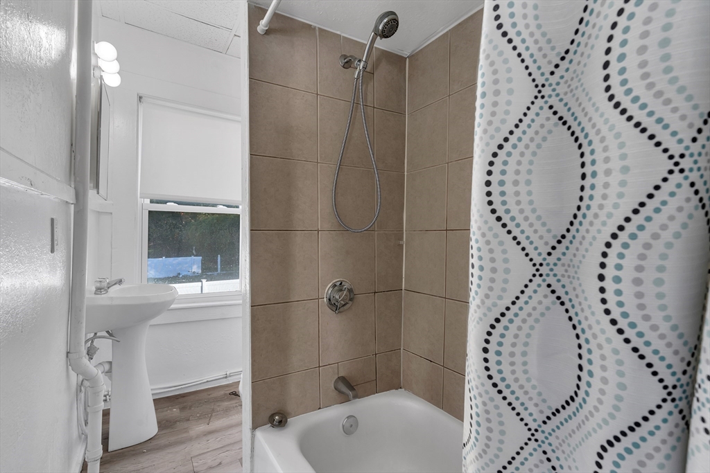 13 R Plain Street, Unit 2 Taunton, MA 02780 - Photo 9 of 21 a bathroom with a bathtub and a shower