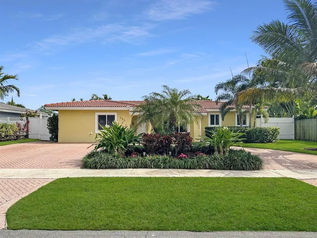 a kitchen with stainless steel appliances granite countertop a refrigerator stove a sink and a microwave