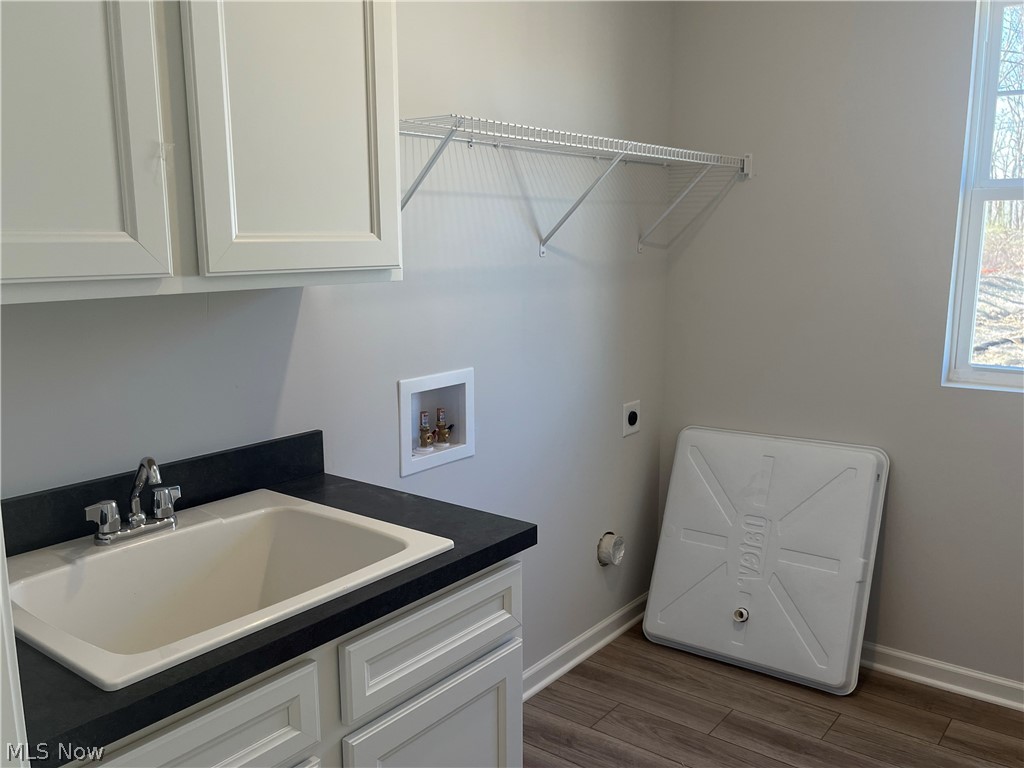 745 River Run Road Aurora, OH 44202 - Photo 5 of 7 Laundry room featuring hookup for washing machine, an electric dryer, sink, cabinets, and wood-style floors
