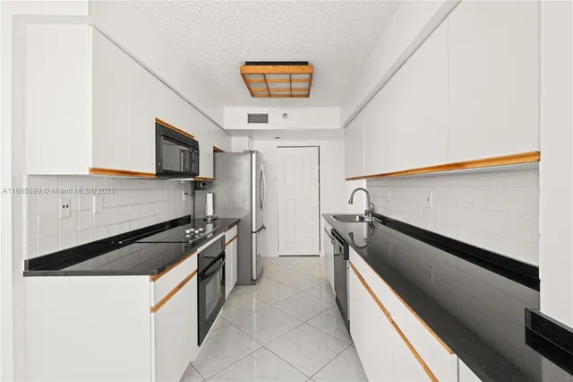 a bathroom with a granite countertop sink a toilet a mirror and shower