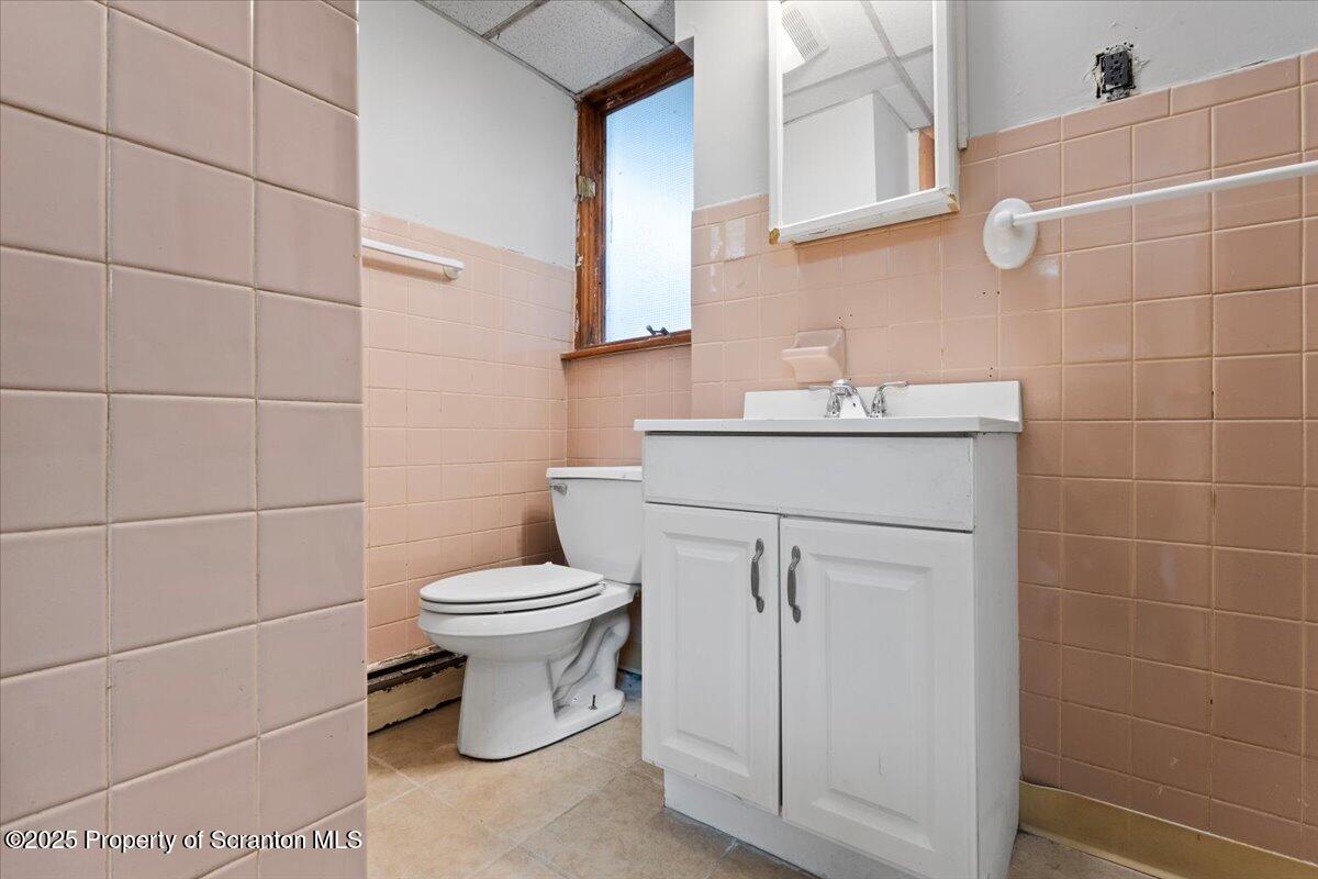 2515 North Main Avenue Scranton, PA 18508 - Photo 18 of 69 a bathroom with a toilet sink and mirror