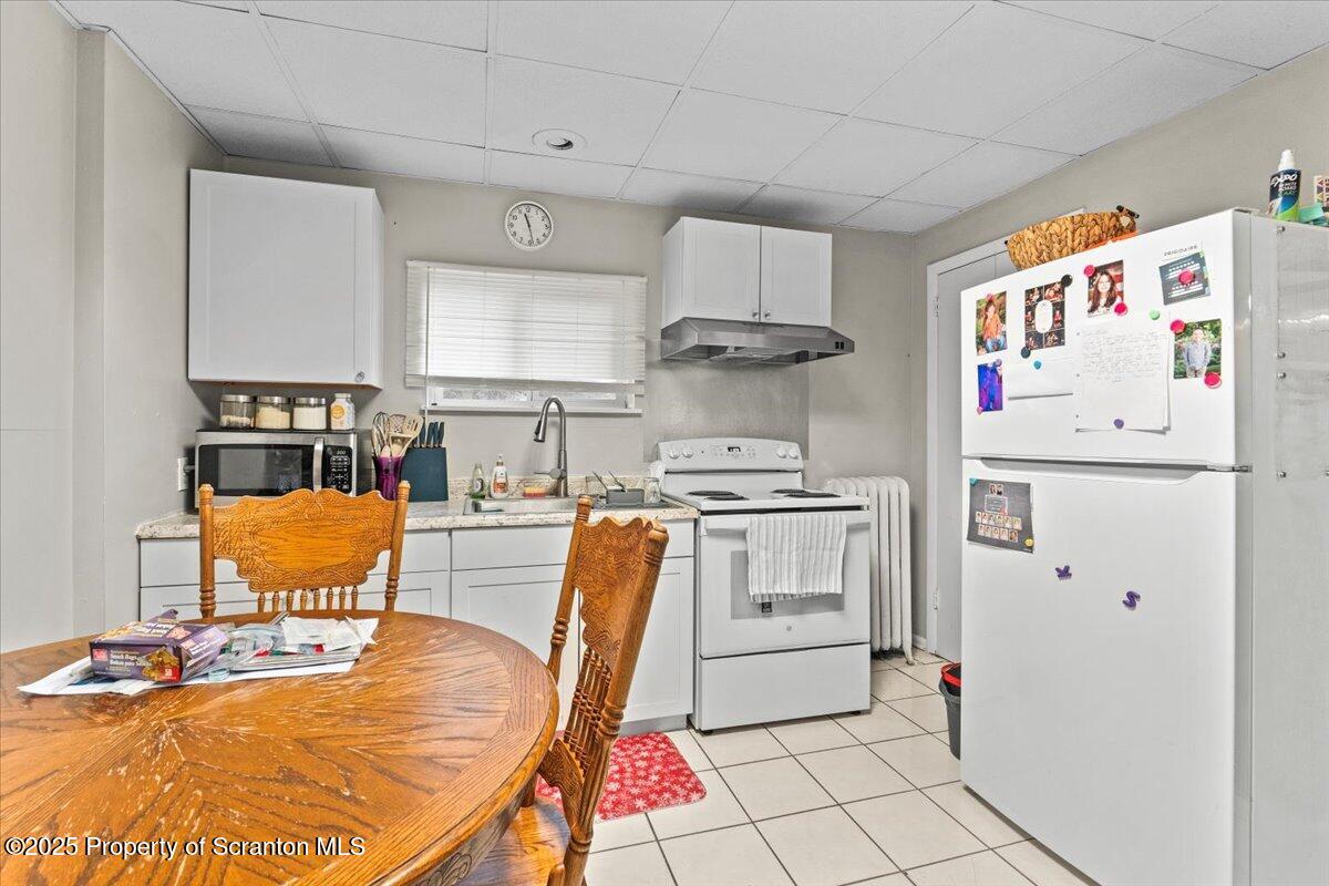 2515 North Main Avenue Scranton, PA 18508 - Photo 38 of 69 a kitchen with stainless steel appliances a refrigerator a stove a dining table and chairs