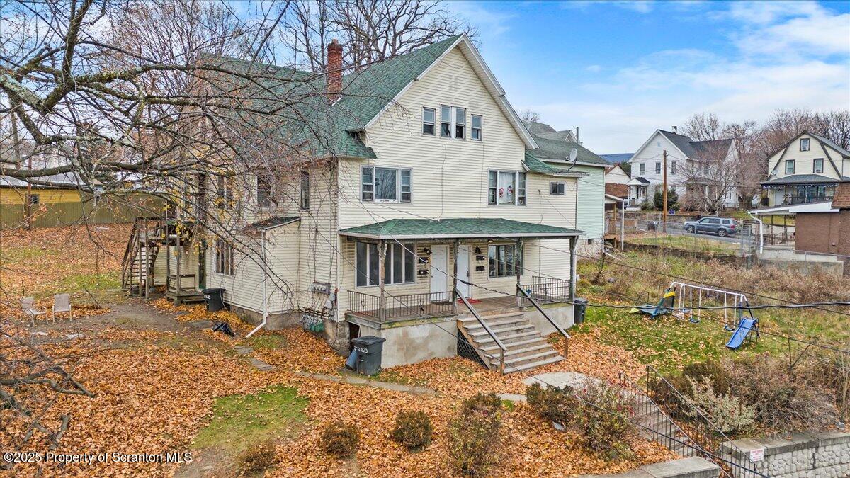 2515 North Main Avenue Scranton, PA 18508 - Photo 4 of 69 a view of a white house with a yard and a wooden deck