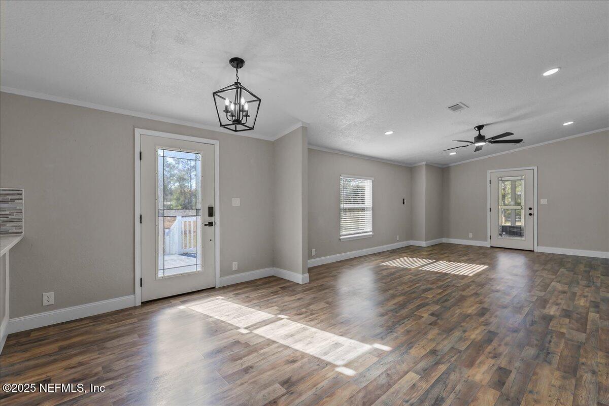 314 Union Avenue Interlachen, FL 32148 - Photo 13 of 30 a view of an empty room with wooden floor and a window