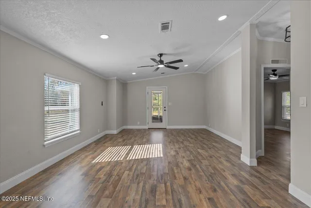 wooden floor in an empty room with a window