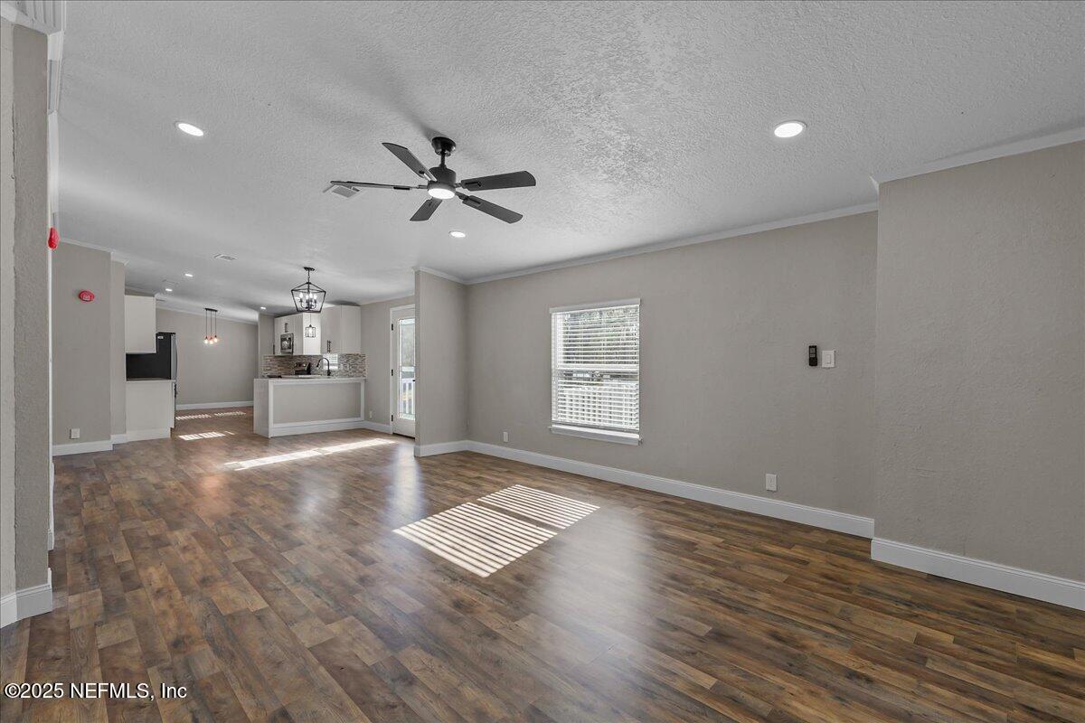 314 Union Avenue Interlachen, FL 32148 - Photo 16 of 30 wooden floor in an empty room with a window