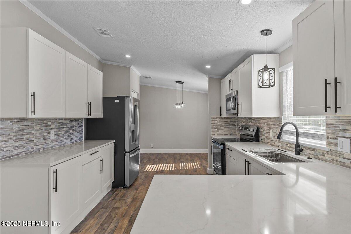 314 Union Avenue Interlachen, FL 32148 - Photo 18 of 30 a large white kitchen with a refrigerator a stove and a sink