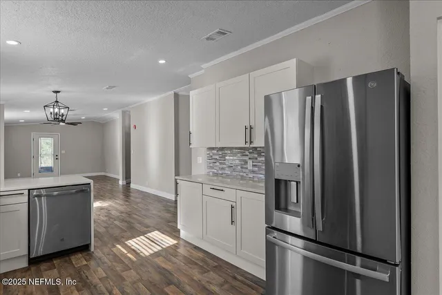 a kitchen with stainless steel appliances a refrigerator and a sink