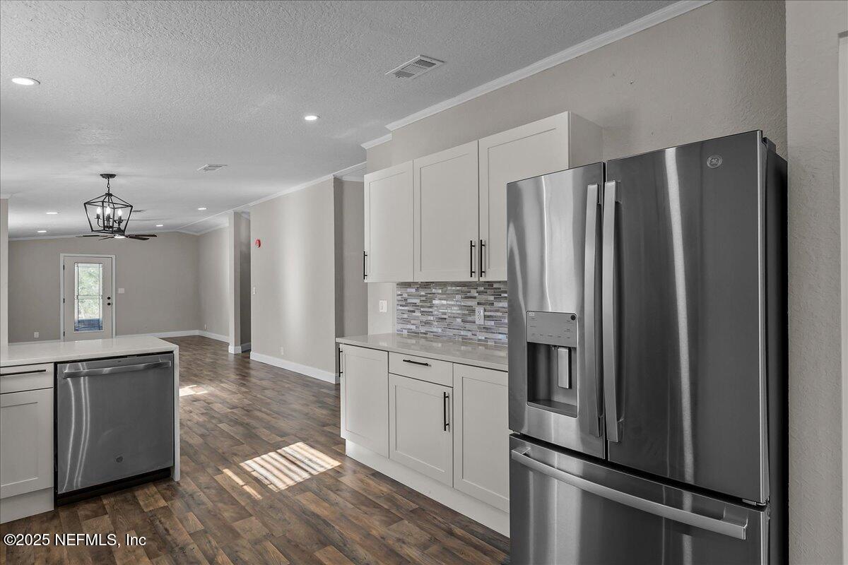314 Union Avenue Interlachen, FL 32148 - Photo 19 of 30 a kitchen with stainless steel appliances a refrigerator and a sink