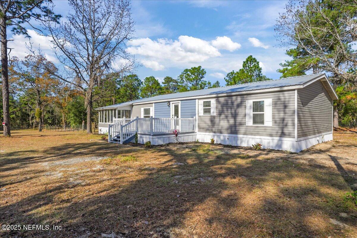 314 Union Avenue Interlachen, FL 32148 - Photo 2 of 30 a view of a house with backyard and a tree