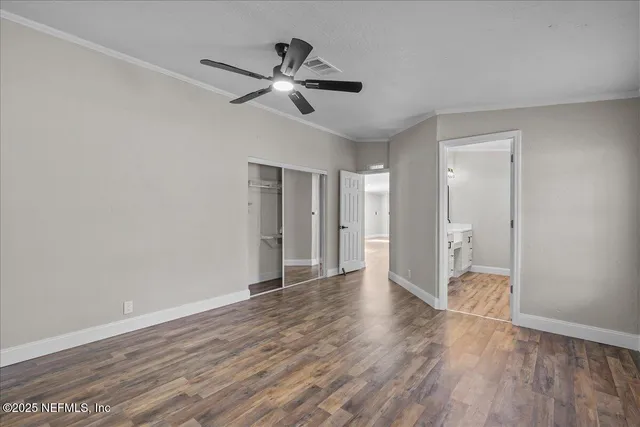 a view of an empty room and wooden floor