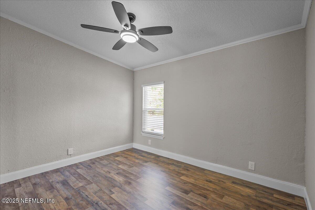 314 Union Avenue Interlachen, FL 32148 - Photo 25 of 30 an empty room with wooden floor and windows