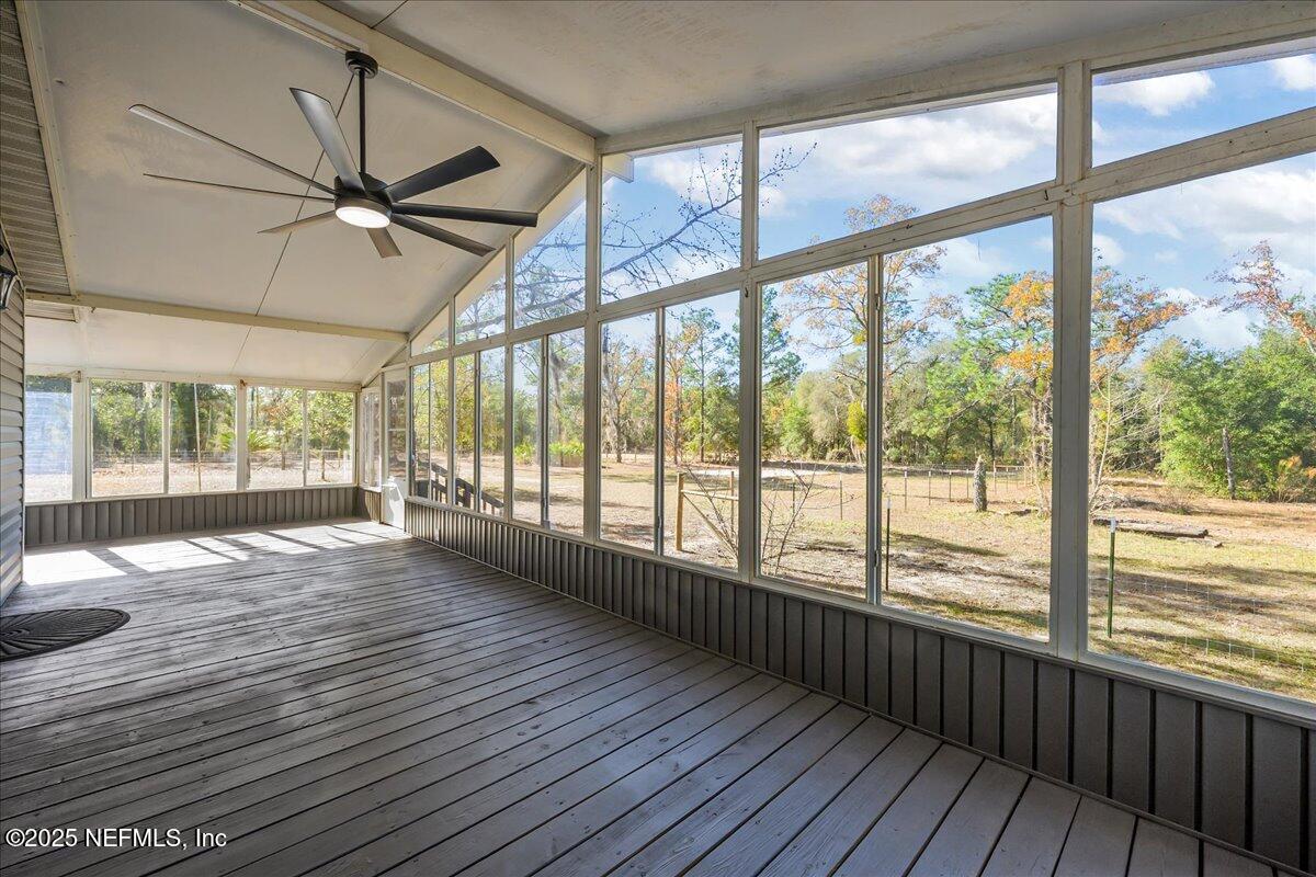 314 Union Avenue Interlachen, FL 32148 - Photo 6 of 30 a view of an empty room with wooden floor and a window