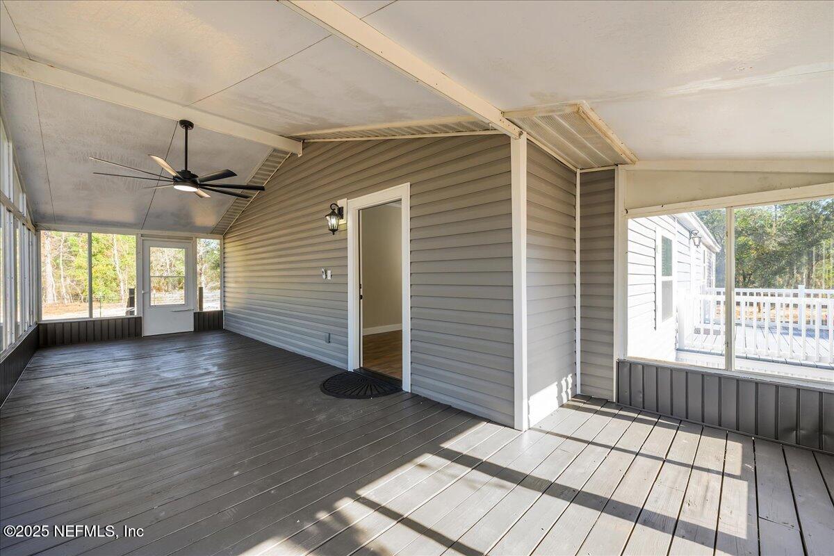 314 Union Avenue Interlachen, FL 32148 - Photo 7 of 30 an empty room with wooden floor and windows