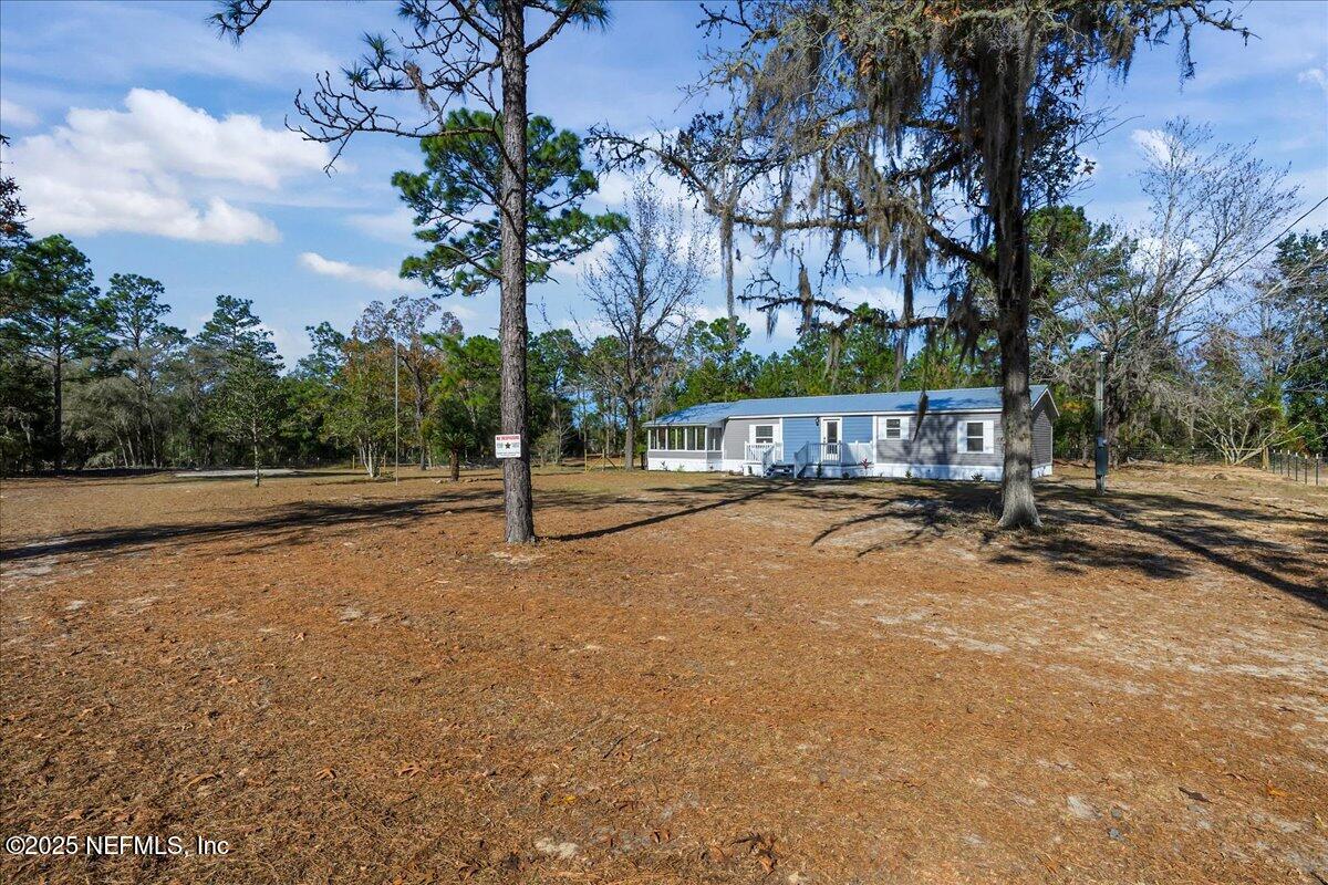 314 Union Avenue Interlachen, FL 32148 - Photo 8 of 30 a view of street with tall trees
