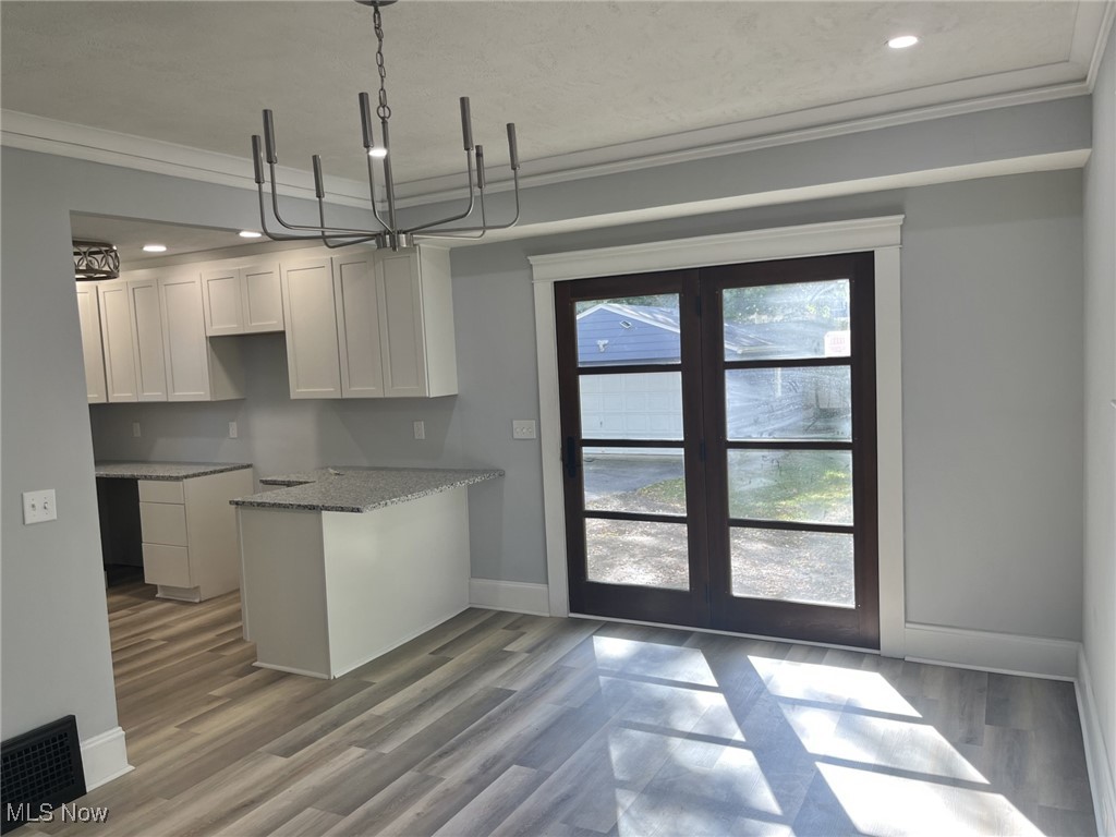 3264 Altamont Road Cleveland, OH 44118 - Photo 10 of 32 Kitchen with crown molding, recessed lighting, white cabinetry, and light wood looking flooring