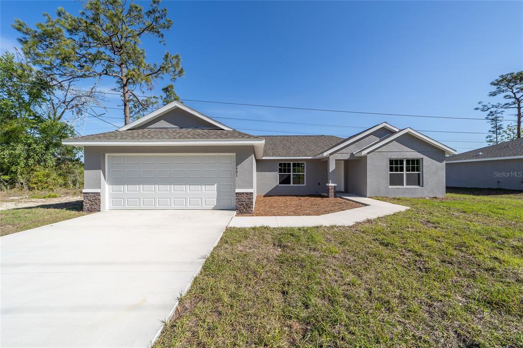 401 West Homeway Loop Citrus Springs, FL 34434 - Photo 1 of 1 a front view of a house with a yard and garage