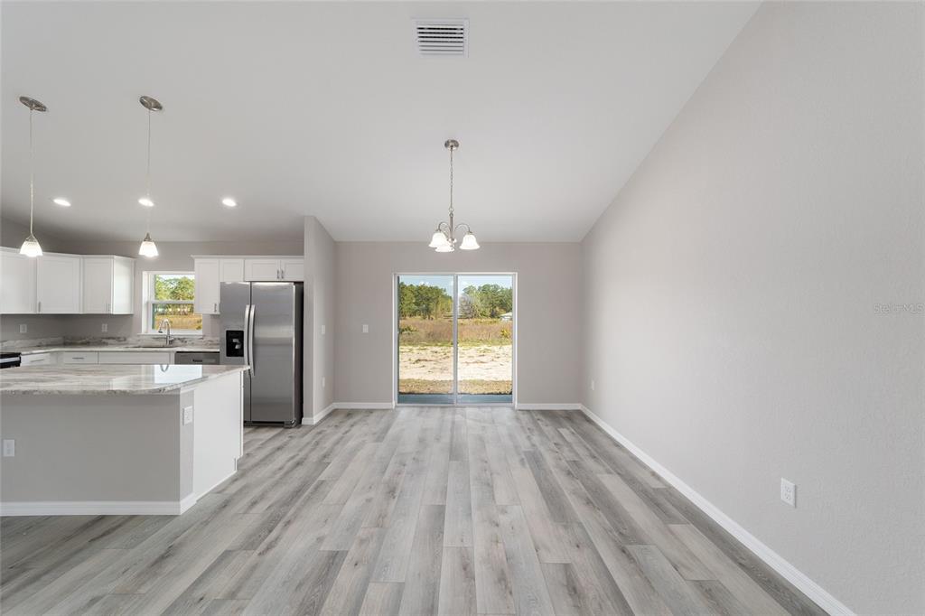 401 West Homeway Loop Citrus Springs, FL 34434 - Photo 12 of 23 a view of kitchen with wooden floor electronic appliances and window