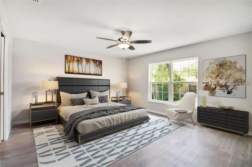 401 West Homeway Loop Citrus Springs, FL 34434 - Photo 15 of 23 a bedroom with a bed and a chandelier