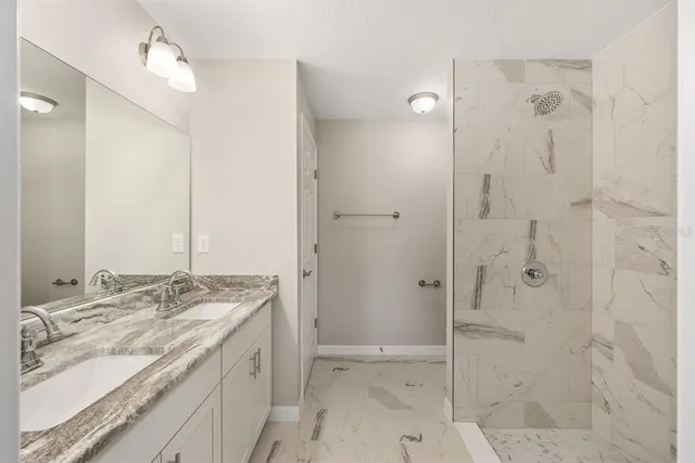 an empty room with wooden floor and ceiling fan
