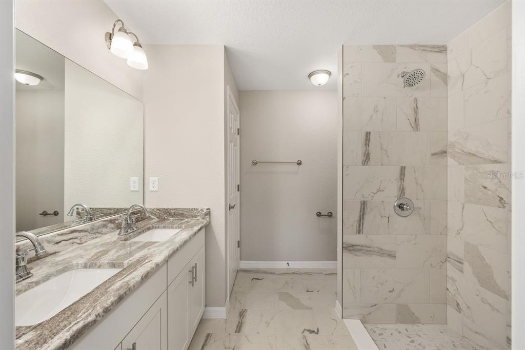 401 West Homeway Loop Citrus Springs, FL 34434 - Photo 17 of 23 a bathroom with a granite countertop sink two mirror and shower