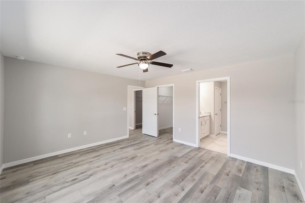 401 West Homeway Loop Citrus Springs, FL 34434 - Photo 18 of 23 an empty room with wooden floor and ceiling fan