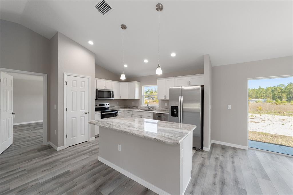 401 West Homeway Loop Citrus Springs, FL 34434 - Photo 2 of 23 a kitchen with refrigerator and window