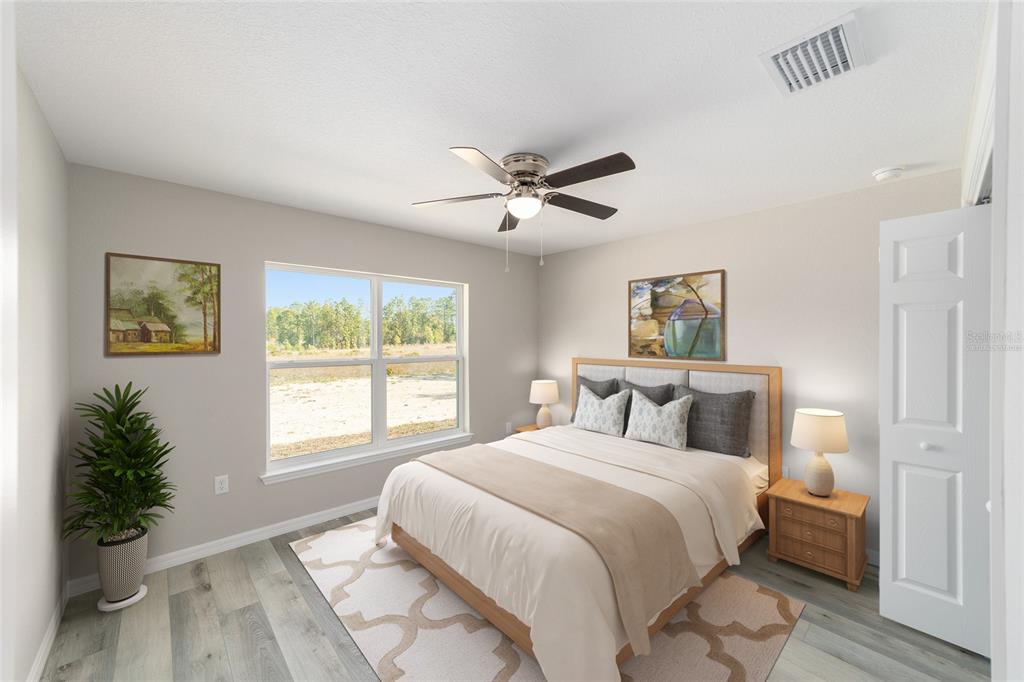 401 West Homeway Loop Citrus Springs, FL 34434 - Photo 22 of 23 a bedroom with a bed and a potted plant