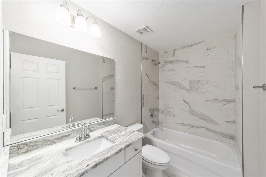 401 West Homeway Loop Citrus Springs, FL 34434 - Photo 23 of 23 a bathroom with a bathtub shower sink vanity mirror and toilet