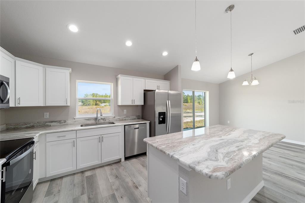 401 West Homeway Loop Citrus Springs, FL 34434 - Photo 4 of 23 a large kitchen with kitchen island a sink stainless steel appliances and cabinets