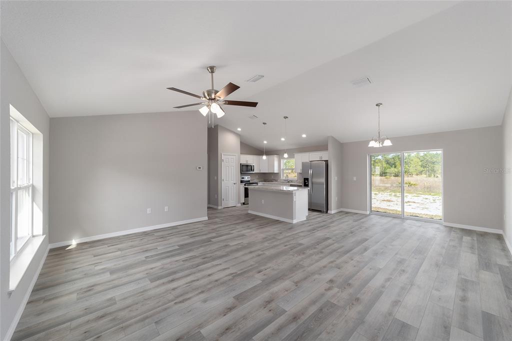 401 West Homeway Loop Citrus Springs, FL 34434 - Photo 9 of 23 a view of a kitchen with a dishwasher cabinets and wooden floor