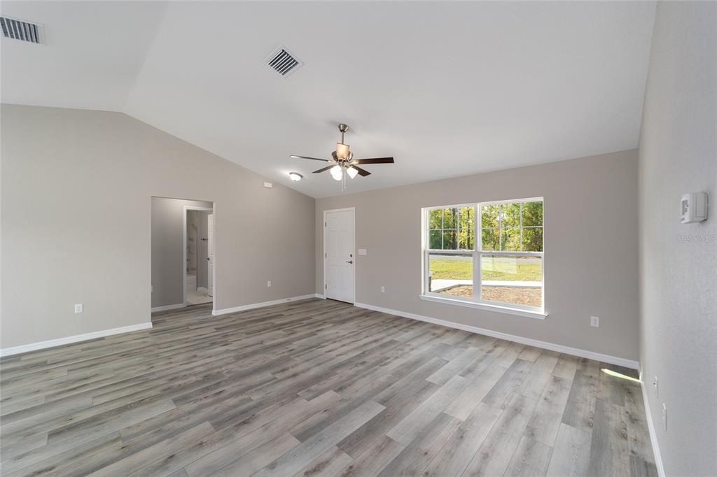 401 West Homeway Loop Citrus Springs, FL 34434 - Photo 10 of 23 an empty room with wooden floor and windows