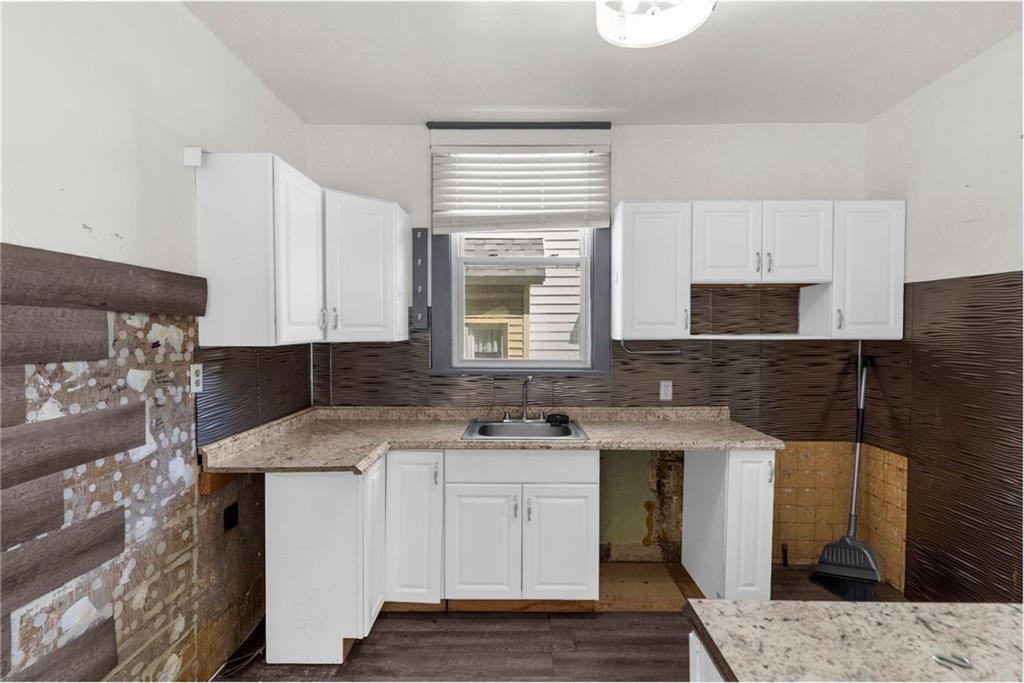 203 Baldwin Avenue Sharon, PA 16146 - Photo 12 of 27 a kitchen with a sink stove and microwave