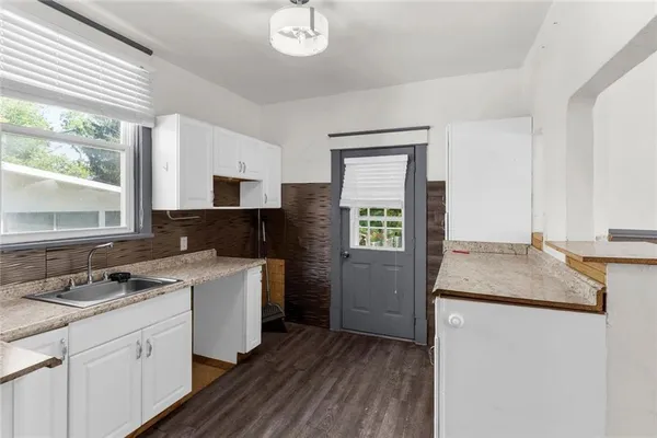 a kitchen with a sink stove and microwave