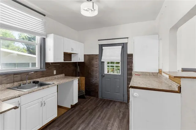 a kitchen with a sink stove and microwave