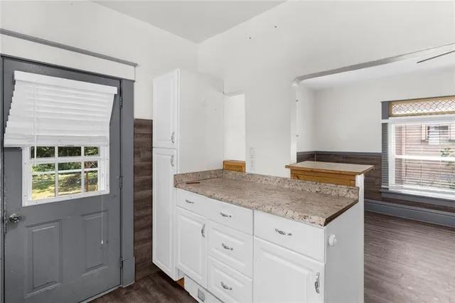 a bathroom with a granite countertop sink and window