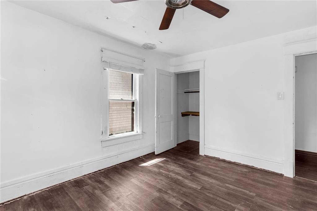 203 Baldwin Avenue Sharon, PA 16146 - Photo 19 of 27 an empty room with wooden floor cabinet and windows