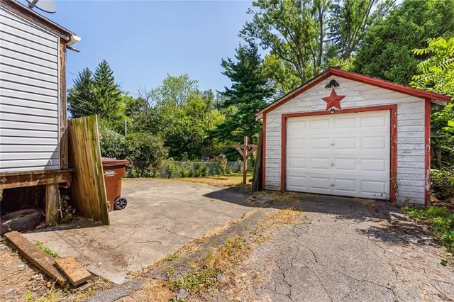 a view of a house with backyard and a tree