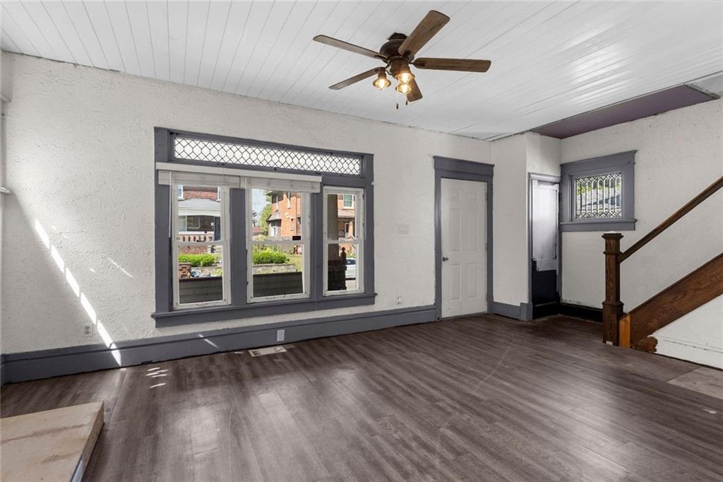 203 Baldwin Avenue Sharon, PA 16146 - Photo 8 of 27 a view of an empty room with wooden floor and a window