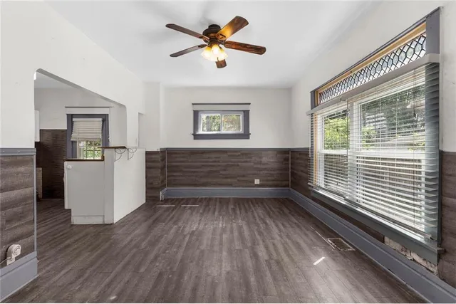 a view of room with window ceiling fan and hardwood floor
