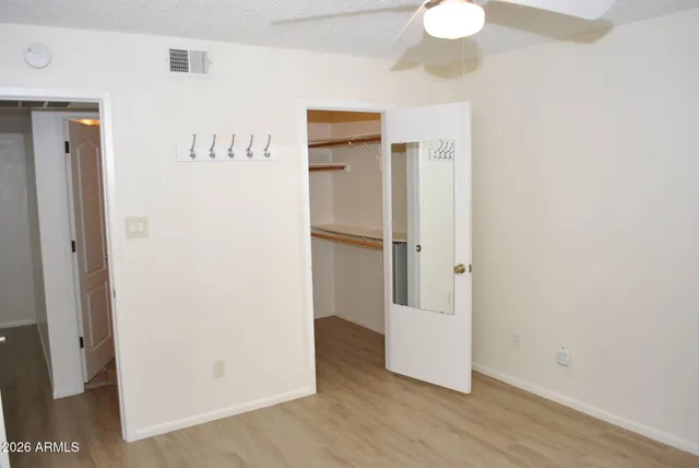 a view of a room with wooden floor and white walls